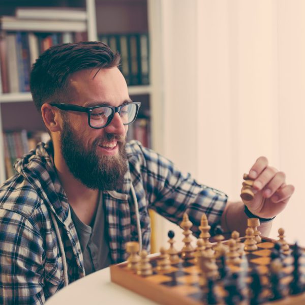 Man playing chess at home, enjoying his leisure time